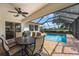 Outdoor patio with furniture overlooking the pool and golf course at 9635 Discovery Ter, Bradenton, FL 34212