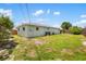 Exterior shot of the backyard showing the lawn, siding, and fencing at 1040 Hope St, Venice, FL 34285