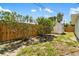 Backyard view featuring wooden fence, vegetation, and an outbuilding at 1040 Hope St, Venice, FL 34285