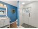 Bright bathroom with glass shower, a vanity, and tile floors at 1040 Hope St, Venice, FL 34285