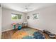 Bright bedroom featuring dual windows, a fan, and space for exercise at 1040 Hope St, Venice, FL 34285