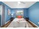 Bright bedroom with blue walls, a ceiling fan, and decorative pillows at 1040 Hope St, Venice, FL 34285