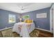Bright bedroom featuring a ceiling fan and dual windows at 1040 Hope St, Venice, FL 34285