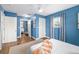 Cozy bedroom with ensuite bath featuring wood floors and a light blue wall at 1040 Hope St, Venice, FL 34285