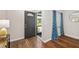Welcoming entryway featuring stylish dark laminate floors, a front door and a modern lamp at 1040 Hope St, Venice, FL 34285