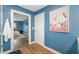 Hallway leading to bedroom and bathroom with art on the wall at 1040 Hope St, Venice, FL 34285