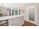 Modern kitchen with white cabinets and stainless steel appliances that opens into living space with an exterior door at 1040 Hope St, Venice, FL 34285