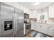 Bright kitchen with stainless steel appliances and white cabinets, offering a modern and functional space at 1040 Hope St, Venice, FL 34285