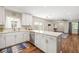 Open kitchen with white cabinets, stainless steel appliances, and a seamless connection to the living area at 1040 Hope St, Venice, FL 34285