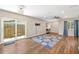 Open-concept living room featuring wood floors and a sliding door to the outside at 1040 Hope St, Venice, FL 34285