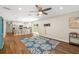 Bright living room with hardwood floors, a ceiling fan, and open layout to the kitchen at 1040 Hope St, Venice, FL 34285
