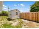 Backyard storage shed with siding and a wood fence surround at 1040 Hope St, Venice, FL 34285