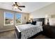 Cozy bedroom featuring a ceiling fan, natural light, and stylish decor at 11411 Spring Gate Trl, Bradenton, FL 34211