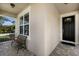 Inviting front porch with a bench, black front door, and tiled flooring at 11411 Spring Gate Trl, Bradenton, FL 34211