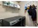 Convenient laundry room with a washer, dryer, and overhead storage at 11411 Spring Gate Trl, Bradenton, FL 34211