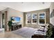 Cozy living room with ample natural light, a comfortable leather sofa, and a view of the pool area through large windows at 11411 Spring Gate Trl, Bradenton, FL 34211