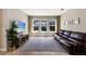 Comfortable living room with hardwood floors and a view of the pool at 11411 Spring Gate Trl, Bradenton, FL 34211