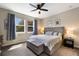 Relaxing main bedroom with a gray upholstered bed and natural light at 11411 Spring Gate Trl, Bradenton, FL 34211