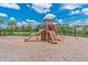 Community playground with a slide, climbing structure, and safety surfacing at 11411 Spring Gate Trl, Bradenton, FL 34211