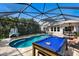 Backyard pool with spa, sun loungers, outdoor bar, and a shaded lounge area at 11411 Spring Gate Trl, Bradenton, FL 34211