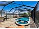 Inviting backyard pool area with a spa, sun loungers, dining set, and lush landscaping at 11411 Spring Gate Trl, Bradenton, FL 34211