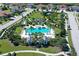 Aerial view of a community pool area surrounded by lush landscaping and neighborhood streets at 11603 Bluebird Pl, Lakewood Ranch, FL 34211