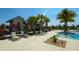 Community pool deck with chairs, lush landscaping, and a view of a neighborhood building at 11603 Bluebird Pl, Lakewood Ranch, FL 34211