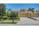 Charming home featuring a tile roof, two-car garage, brick paver driveway and lush green landscaping at 11603 Bluebird Pl, Lakewood Ranch, FL 34211