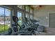 Well-equipped gym overlooking the pool, offering state-of-the-art equipment and scenic views for an active lifestyle at 11603 Bluebird Pl, Lakewood Ranch, FL 34211