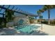 Community hot tub with brick accents, a pergola and lush landscaping at 11603 Bluebird Pl, Lakewood Ranch, FL 34211