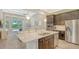 Open-concept kitchen and living area with stainless steel appliances and a large island perfect for entertaining at 11603 Bluebird Pl, Lakewood Ranch, FL 34211