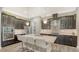Modern kitchen with dark cabinets, a center island, stainless steel appliances, and stylish pendant lighting at 11603 Bluebird Pl, Lakewood Ranch, FL 34211