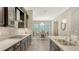 Modern kitchen featuring stainless steel appliances, granite countertops, and a view into the dining area at 11603 Bluebird Pl, Lakewood Ranch, FL 34211