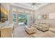 Bright living room featuring a large sliding glass door, neutral color palette, and comfortable furnishings at 11603 Bluebird Pl, Lakewood Ranch, FL 34211