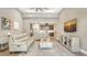 Spacious living room open to kitchen, featuring high ceilings, neutral colors, and modern furnishings at 11603 Bluebird Pl, Lakewood Ranch, FL 34211