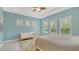 Bright main bedroom with a neutral color palette, a cozy sofa, and natural light streaming through shuttered windows at 11603 Bluebird Pl, Lakewood Ranch, FL 34211