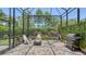 Cozy screened patio area featuring a fire pit, grill, and seating for outdoor entertaining at 11603 Bluebird Pl, Lakewood Ranch, FL 34211