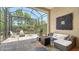 Outdoor patio with pavers, screened in patio, outdoor kitchen, grill, and lush green privacy plants at 11603 Bluebird Pl, Lakewood Ranch, FL 34211
