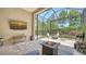 Relaxing screened patio with brick pavers, fire pit, TV, and comfortable seating area at 11603 Bluebird Pl, Lakewood Ranch, FL 34211
