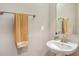 Classic powder room featuring a sleek pedestal sink, framed mirror, brushed nickel hardware, and neutral paint at 11603 Bluebird Pl, Lakewood Ranch, FL 34211