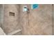 Shower features diagonally patterned tiling, a shower head, built-in alcove, and bench seat at 11603 Bluebird Pl, Lakewood Ranch, FL 34211