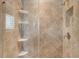 Shower features large diagonally patterned tiling, a shower caddy, and a built-in alcove for storage at 11603 Bluebird Pl, Lakewood Ranch, FL 34211