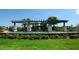 Landscaped water feature with a pergola that offers a tranquil outdoor space with seating and lush surroundings at 11603 Bluebird Pl, Lakewood Ranch, FL 34211