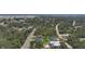 Aerial view of the property highlighting its location within a lush, wooded neighborhood at 11960 De Leon Dr, North Port, FL 34287