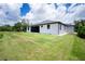A pristine backyard with lush green grass and a white modern home, perfect for outdoor living at 11960 De Leon Dr, North Port, FL 34287