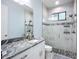 Modern bathroom with granite counters, tiled shower, and contemporary fixtures at 11960 De Leon Dr, North Port, FL 34287