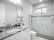 Bright bathroom with double vanity, granite countertop, and glass door walk-in shower with marble tile at 11960 De Leon Dr, North Port, FL 34287
