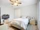 Light and airy bedroom featuring a ceiling fan, and gray laminate flooring at 11960 De Leon Dr, North Port, FL 34287
