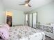 Spacious bedroom featuring a walk-in closet, light green walls, and modern furnishings at 11960 De Leon Dr, North Port, FL 34287