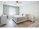 Light and airy bedroom with floral bedding, soft green walls, and ample storage space at 11960 De Leon Dr, North Port, FL 34287